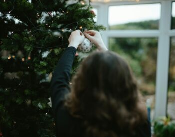 A women decorating her Chirstmas Tree