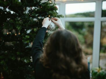 A women decorating her Chirstmas Tree